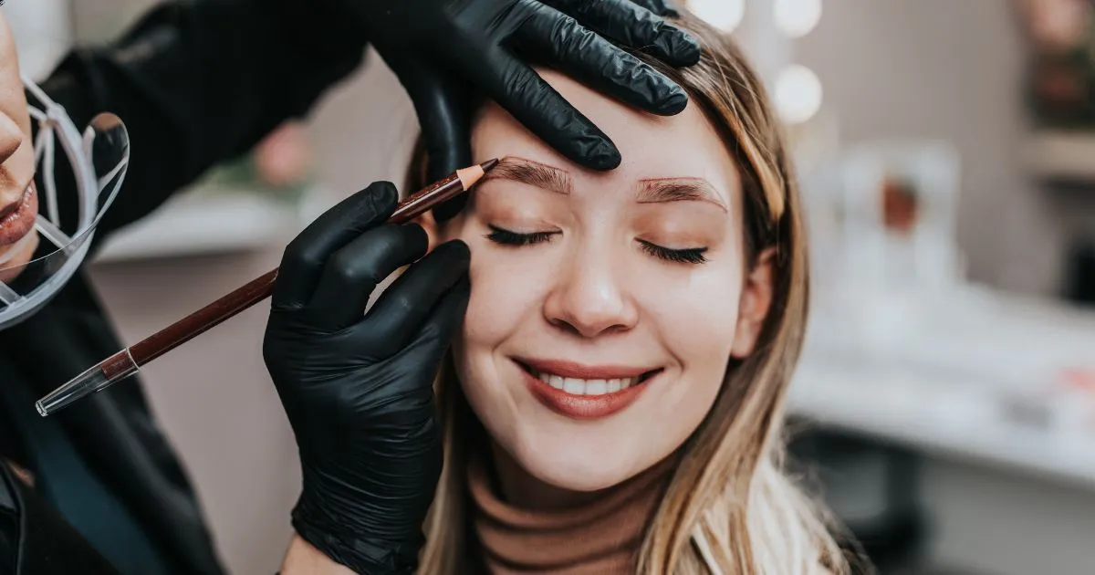 Technician performing a cosmetic treatment on the face, representing a microblading or cosmetic tattooing procedure